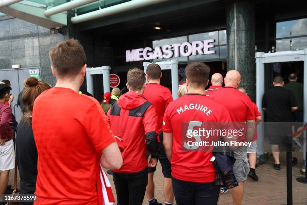 Manchester United fans enter the megastore prior to the Premier League match between Manchester United and Chelsea FC at Old Trafford on August 11,...
