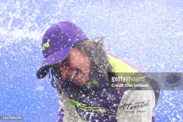 Jamie Chadwick of Great Britain celebrates on the podium after winning the inaugural W Series Championship at Brands Hatch on August 11, 2019 in...