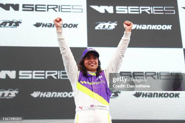 Jamie Chadwick of Great Britain celebrates on the podium after winning the inaugural W Series Championship at Brands Hatch on August 11, 2019 in...