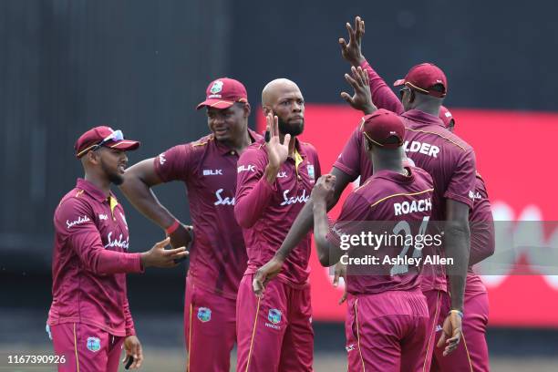 Roston Chase of West Indies celebrate a wicket with his teammates during the second MyTeam11 ODI between the West Indies and India at the Queen's...