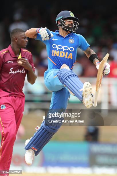 Virat Kohli of India celebrates his century during the second MyTeam11 ODI between the West Indies and India at the Queen's Park Oval on August 11,...