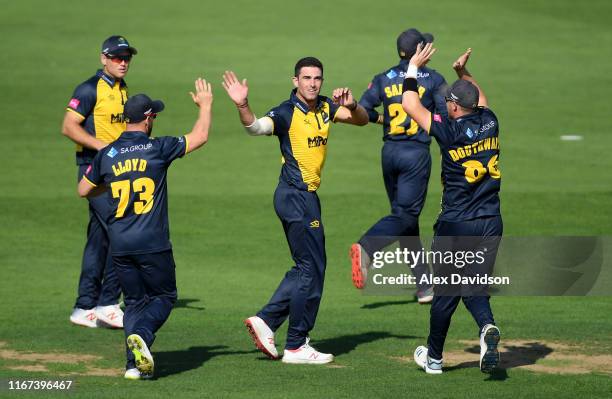 Ruaidhri Smith of Glamorgan celebrates the wicket of Mark Stoneman of Surrey with his teammates during the Vitality Blast match between Glamorgan and...