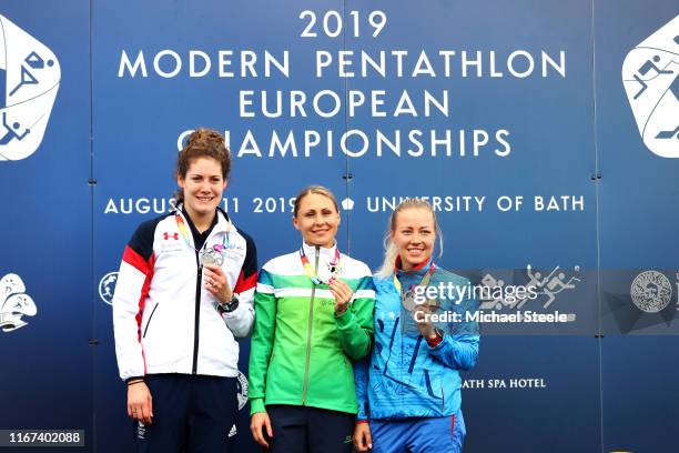Kate French of Great Britain poses with the silver medal, Laura Asadauskaite of Lithuania with the gold medal and Volha Silkina of Belarus with the...