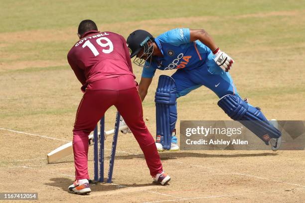 Kedar Jadhav of India is run-out by Evin Lewis and Sheldon Cottrell of the West Indies during the second MyTeam11 ODI between the West Indies and...