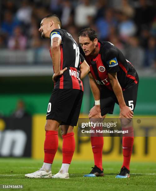 Sebastian Mrowca of SV Wehen Wiesbaden and Benedikt Roecker of SV Wehen Wiesbaden show their disappointment during the DFB Cup first round match...