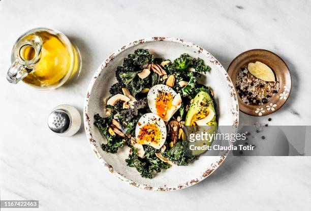 bowl of kale salad with boiled eggs and avocado on white background - vegetarian meal stock pictures, royalty-free photos & images
