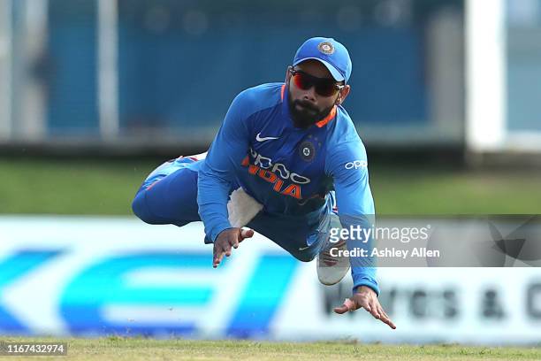 Virat Kohli of India dives as he attempts to save four runs during the second MyTeam11 ODI between the West Indies and India at the Queen's Park Oval...