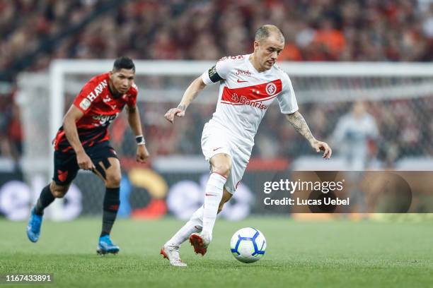 Andres D'alessandro of Internacional controls the ball against Rony of Athletico PR during the match between Athletico PR and Internacional as part...