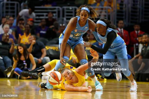 Forward Cheyenne Parker of the Chicago Sky steps over center Maria Vadeeva of the Los Angeles Sparks as guard Kahleah Copper of the Chicago Sky...