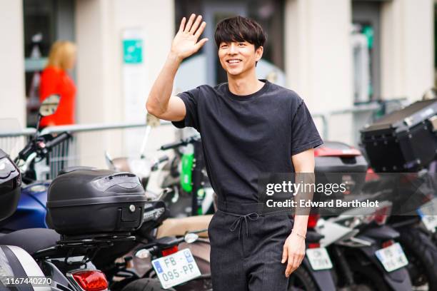 Gong Yoo wears a black t-shirt, black pants with a bow belt, outside Vuitton, during Paris Fashion Week - Menswear Spring/Summer 2020, on June 20,...