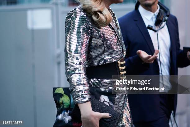 Guest wears a glittering metal mesh jacket, a large black belt, outside the "Scandal A Paris" : Jean-Paul Gaultier's New Fragance Launch Dinner Party...