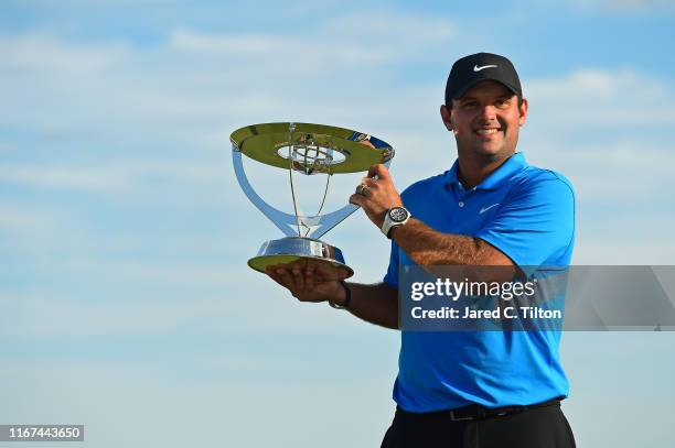 Patrick Reed of the United States celebrates with the winner's trophy after the final round of The Northern Trust at Liberty National Golf Club on...