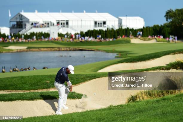 Louis Oosthuizen of South Africa plays a shot from a bunker on the 13th hole during the final round of The Northern Trust at Liberty National Golf...