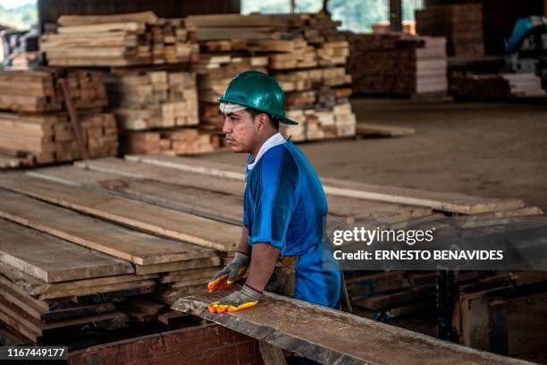 Man works at a sawmill near Puerto Maldonado, Tambopata province, Madre de Dios region, in the Amazon rainforest of southeastern Peru, on September...