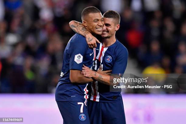 Kylian Mbappe of Paris Saint-Germain is congratulated by teammate Marco Verratti after scoring during the Ligue 1 match between Paris Saint-Germain...