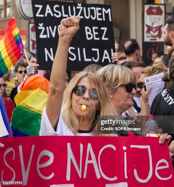 Protester raises her fist while blowing a whistle during the pride parade. "Ima Izac!" translated as "Open the door, please" was the motto of the...