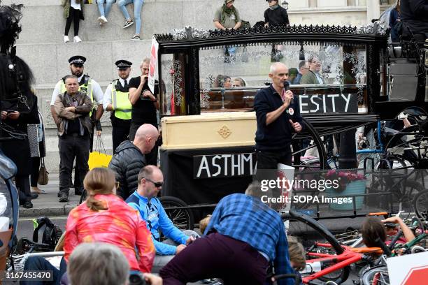 Co-founder Stop Killing Cyclists Donnachadh McCarthy speaks during the demonstration. Cyclists participated in a funeral procession through central...