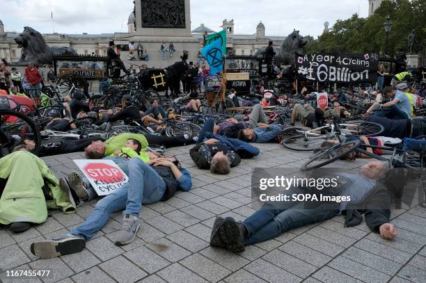 Protesters hold a die-in during the demonstration. Cyclists participated in a funeral procession through central London protesting against the death...