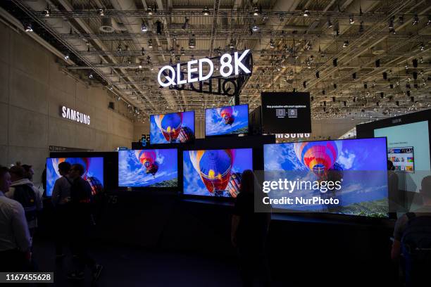 Visitors with the background of Qled 8K screens at Samsung boot during the international electronics and innovation fair IFA in Berlin on September...