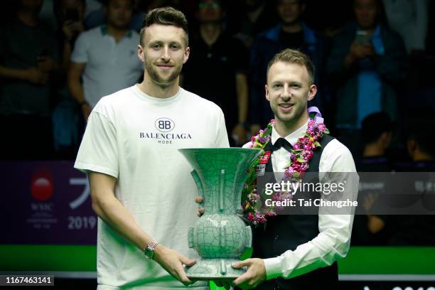 Judd Trump of England celebrates with his trophy after the final match against Shaun Murphy of England on day eight of the 2019 World Snooker...