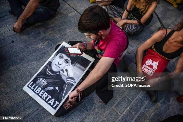 Protester with the banner of Anna Gabriel, leader of the Popular Unity Candidacy , currently in exile in Switzerland seen during the demonstration on...