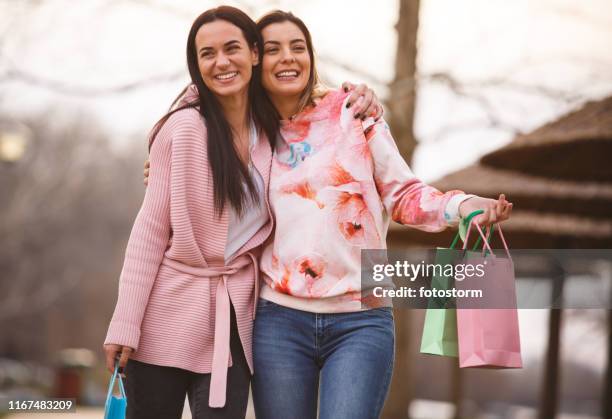 cheerful young women having fun after going shopping together - real people shopping stock pictures, royalty-free photos & images