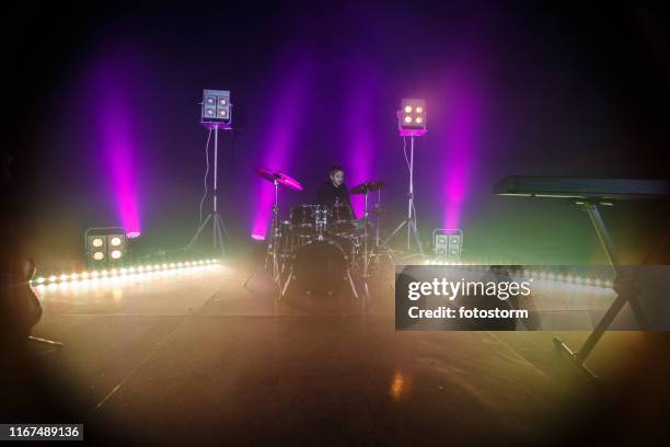 little drummer behind big set of drums - big spotlights stock pictures, royalty-free photos & images
