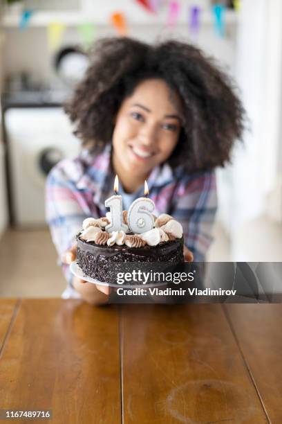 cheerful woman holding birthday cake with candles - 16th birthday stock pictures, royalty-free photos & images