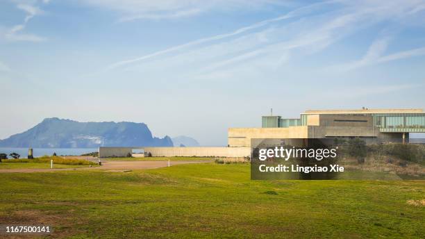 the scenic view of seongsan ilchulbong with glass house by tadao ando, jeju island, south korea - tadao ando stock pictures, royalty-free photos & images