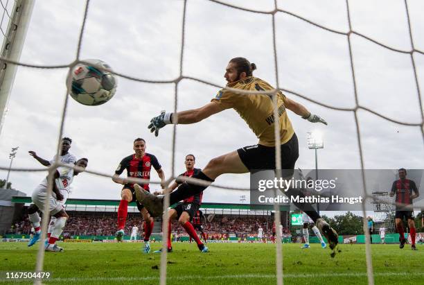 John Cordoba of 1. FC Koeln scores his team's first goal past goalkeeper Lukas Watkowiak of SV Wehen Wiesbaden during the DFB Cup first round match...