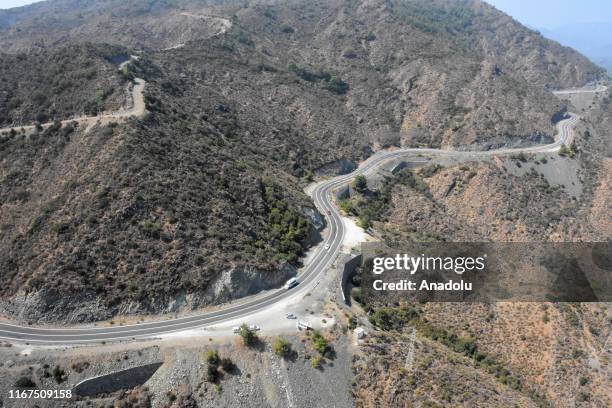 An aerial view of cars going on a road near the rally route as the test drives take place during shakedown lap within the World Rally Championship at...