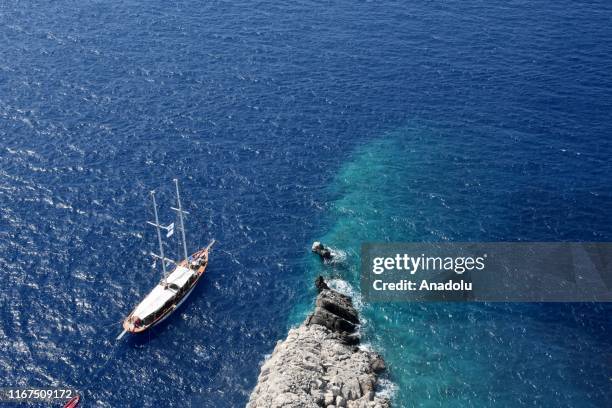 An aerial view of a vessel going at sea near the route where test drives take place in the shakedown lap within the World Rally Championship at...