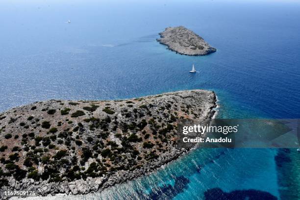 An aerial view of a sailing boat going at sea near the route where test drives take place in the shakedown lap within the World Rally Championship at...