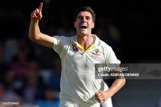 Australia's Pat Cummins celebrates dismissing England's captain Joe Root for 57 runs during play on the first day of the fifth Ashes cricket Test...