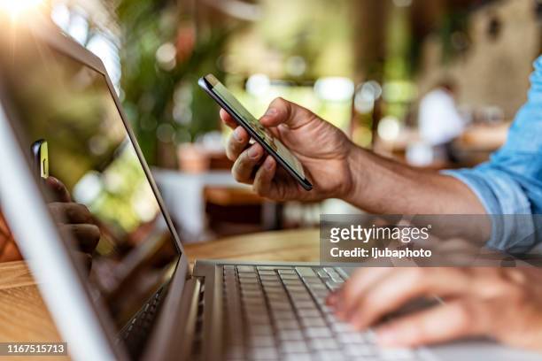 multitasking saves him plenty of time in the office - consumer electronics industry stock pictures, royalty-free photos & images
