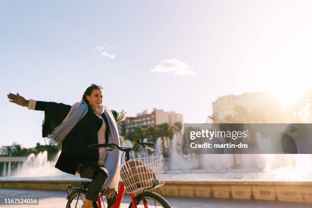 carefree girl riding bicycle in valencia,spain - spring city break stock pictures, royalty-free photos & images