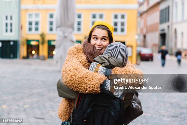 young couple hugging, laughing and having fun - copenhagen winter stock-fotos und bilder