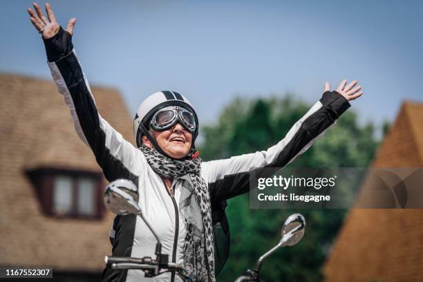 84 years old senior woman on electric scooter - crash helmet stock pictures, royalty-free photos & images