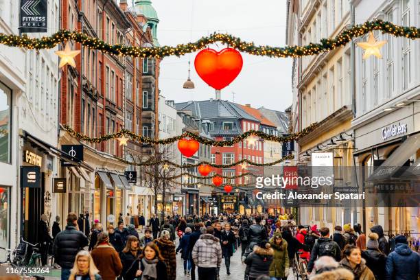 shopping street in historical center of copenhagen decorated for christmas holidays, denmark - copenhagen stock pictures, royalty-free photos & images
