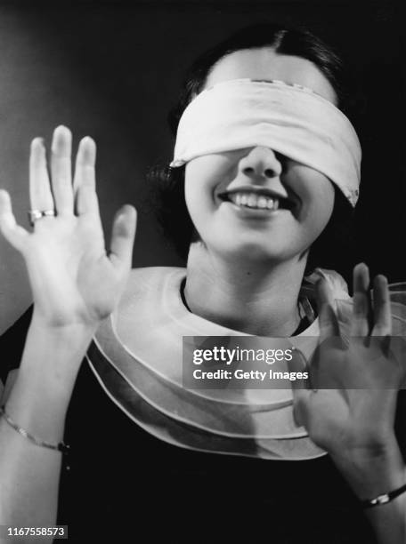 A Blindfolded Woman with Her Hands on Her Face · Free Stock Photo