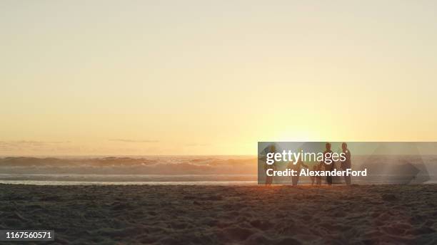 find us on the beach until the sun sets - family silhouette stock pictures, royalty-free photos & images