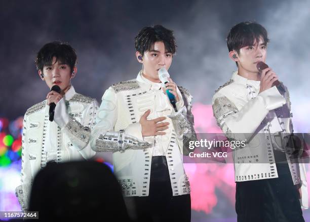 Singer/songwriter Roy Wang Yuan, singer Karry Wang Junkai and singer/dancer Jackson Yee of boy group TFBoys perform during their concert 'The Fever'...