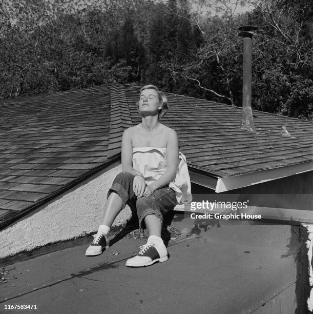 American actress Barbara Bel Geddes sunning herself on the roof of her new home in Brentwood, California, circa 1950. She is starring in the new 20th...