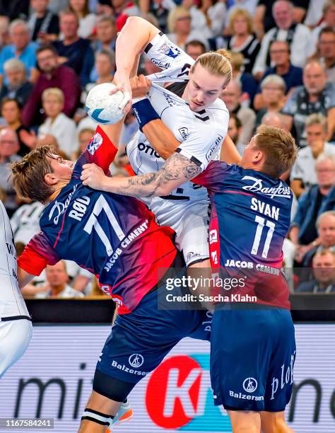 Lukas Nilsson challenges Lasse Svan and Magnus Röd during the Liqui Moly HBL match between THW Kiel and SG Flensburg-Handewitt at Sparkassen Arena on...