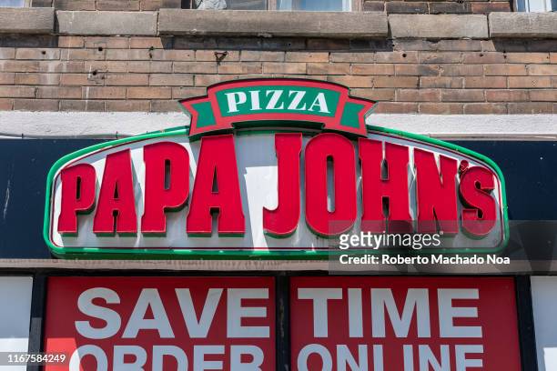 Sign of a Papa John's Pizzeria in the downtown district. This company is an American pizza restaurant franchise running the fourth largest pizza...