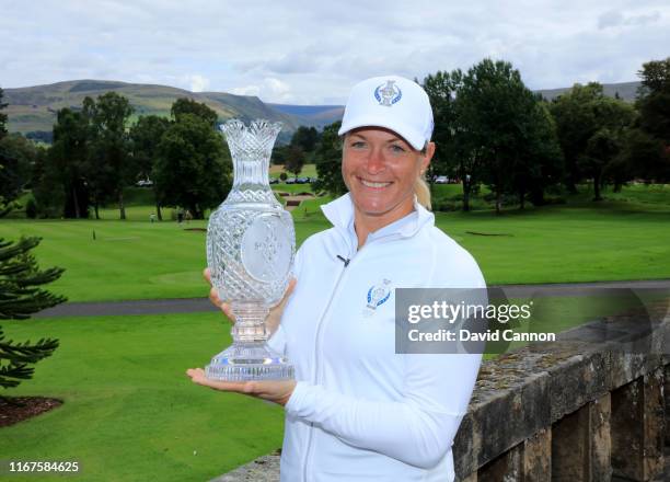 Suzann Pettersen of Norway holds the Solheim Cup beside the Gleneagles Hotel during the European Solheim Cup Team announcement at Gleneagles on...