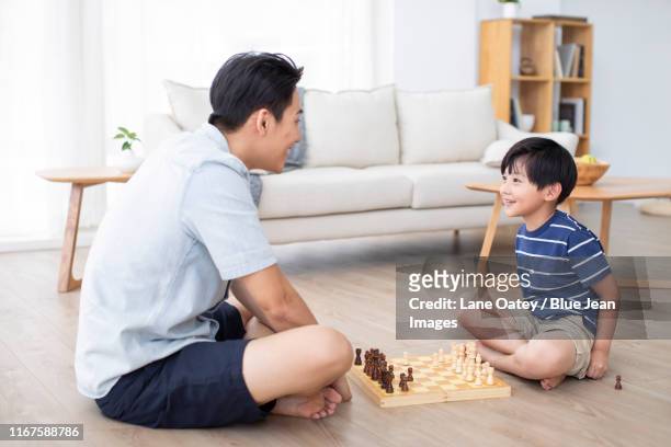 chinese father and son playing chess - kids playing chess stock pictures, royalty-free photos & images