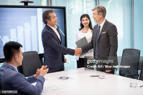 business people shaking hands in conference room - private equity stock pictures, royalty-free photos & images