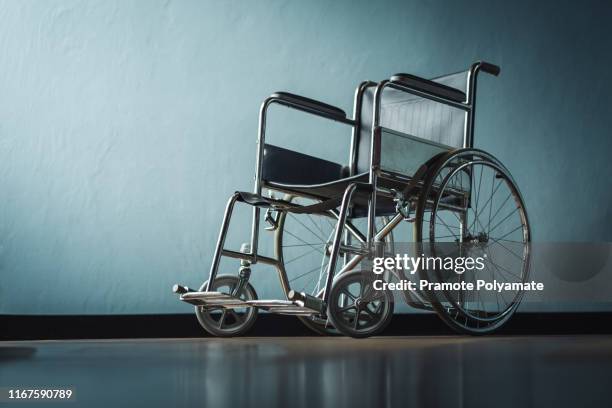 the old wheelchair in the hospital room with light from the window - 車いす ストックフォトと画像