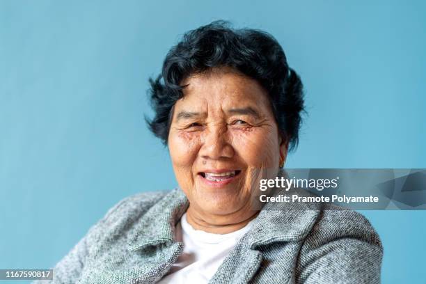 portriat of asian senoir retirement woman in home happy lifestyle. - asian grandmother stock pictures, royalty-free photos & images